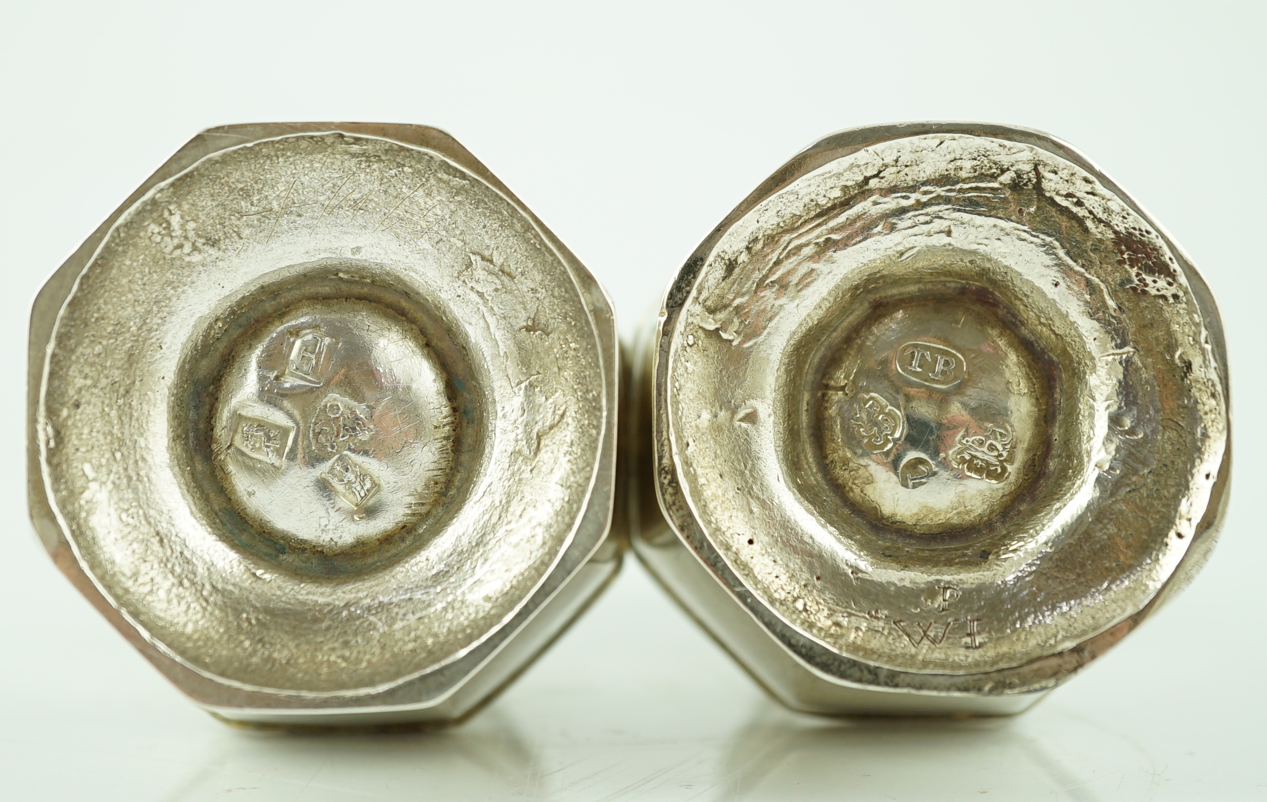 A near pair of George I/George II silver octagonal baluster casters